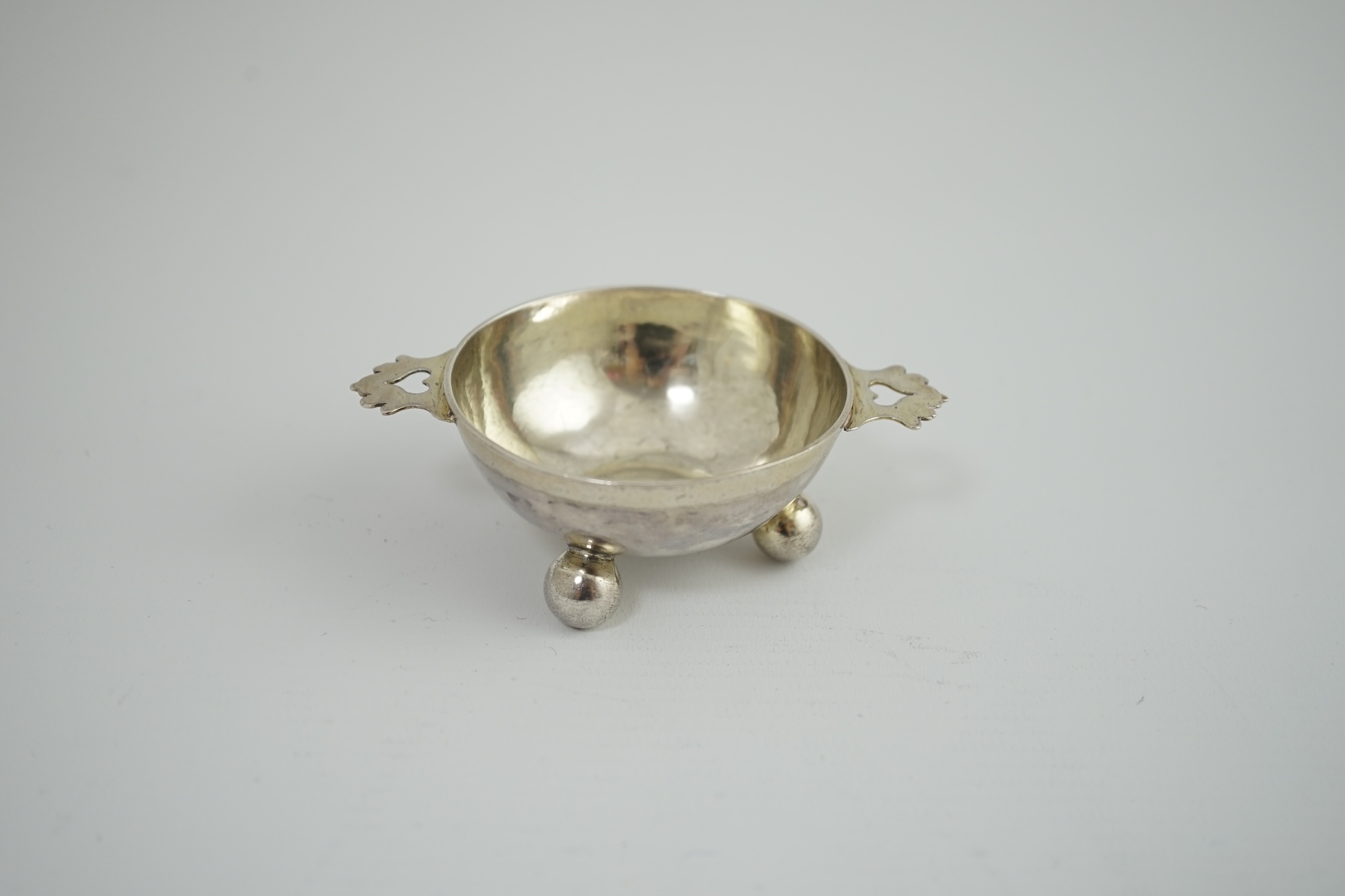 A late 17th century? German Nurnberg silver two handled wine taster, on three ball feet